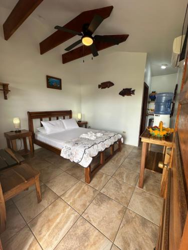 a bedroom with a bed and a ceiling fan at All Seasons Belize in Hopkins