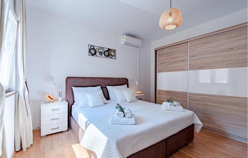 a bedroom with a bed with two towels on it at Beautiful Home In Prigradica in Prigradica