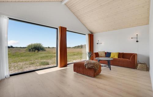 a living room with a couch and a large window at 3 Bedroom Stunning Home In Jerup in Jerup