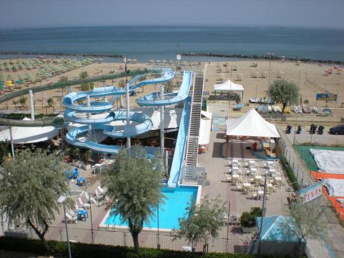 a water park with a pool and a beach at Hotel Villa dei Gerani in Rimini