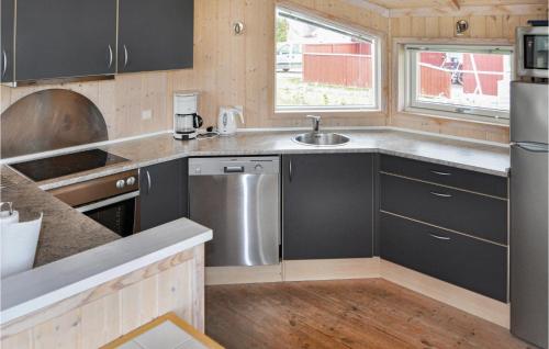 una cucina con armadi neri e lavandino in acciaio inossidabile di Holiday Home Vemmingbund Strandvej Broager I a Broager