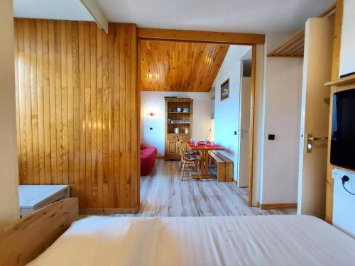 une chambre avec un lit et une table avec des chaises dans l'établissement Résidence Le Trompe L'oeil - TROMPE L’OEIL 13 MAE-0741, à La Plagne Tarentaise