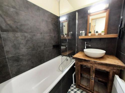 a bathroom with a sink and a bath tub at Résidence Le Sextant - SEXTANT 304 MAE-0871 in La Plagne Tarentaise