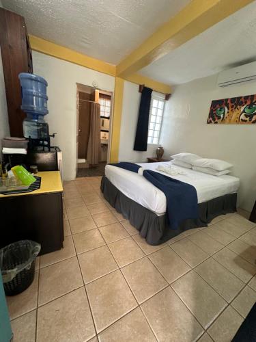 a bedroom with a large bed in a room at All Seasons Belize in Hopkins