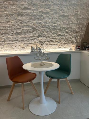a table and two chairs in a room with a window at La Loggetta in Noci