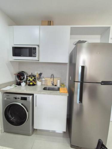 a kitchen with a stainless steel refrigerator and a dishwasher at Apartamento con pileta en Asunción centro in Asuncion