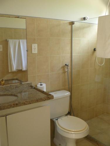 a bathroom with a toilet and a sink at Pé na Areia in Conde