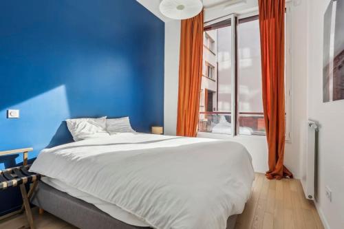 Ένα ή περισσότερα κρεβάτια σε δωμάτιο στο Appartement Le Rostand