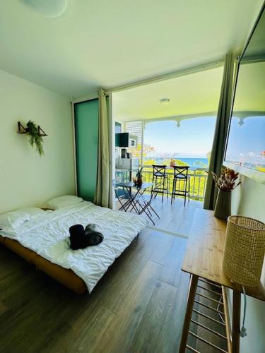 a black cat laying on a bed in a room at 913 Sweety Diamond View in Le Diamant