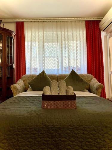 a bedroom with a large bed with red curtains at Apartament Ultraconfort in Iaşi