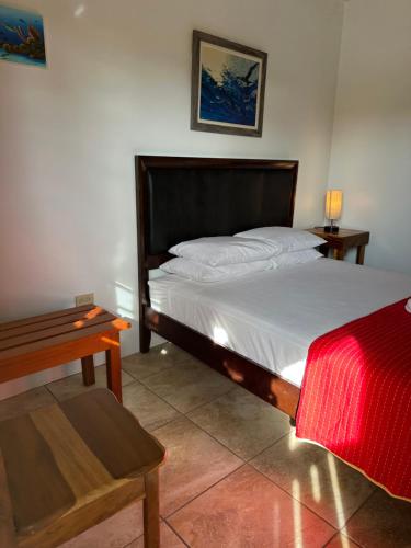 a bedroom with a large bed and a table at All Seasons Belize in Hopkins