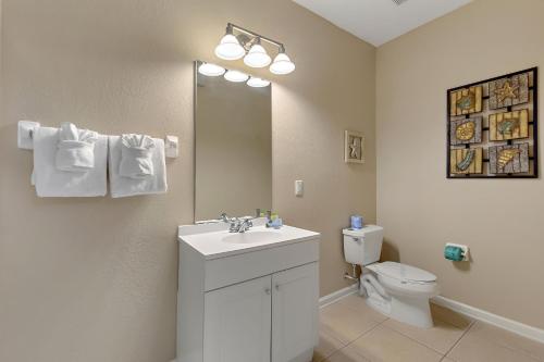 a bathroom with a white sink and a toilet at Vista Cay Resort, Next To Universal #821 in Orlando