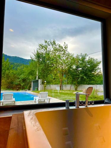 a large window with a view of a swimming pool at Blueberryhouse in İsmayıllı