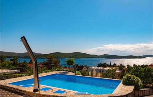 a swimming pool with a view of a lake at Awesome Home In Zaboric With Wifi in Zaboric