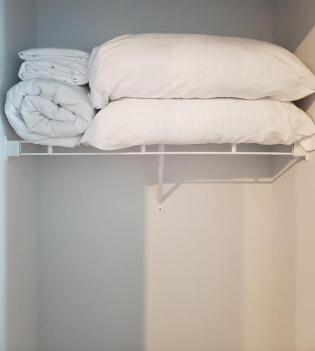 a shelf with a bed and pillows on it at Convenient and Close to All in Kissimmee