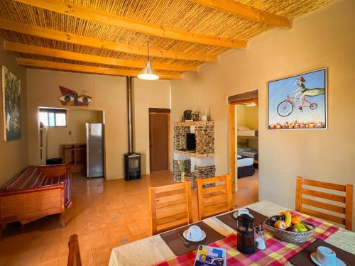 a living room with a table and a dining room at Hostal y Cabañas Renta House San Pedro in San Pedro de Atacama