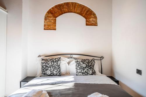 a bedroom with a bed with an arch above it at Borgo la Pieve in Florence