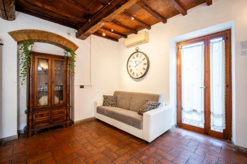 a living room with a couch and a clock on the wall at Borgo la Pieve in Florence
