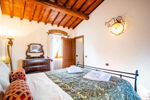 a bedroom with a bed and a mirror at Borgo la Pieve in Florence