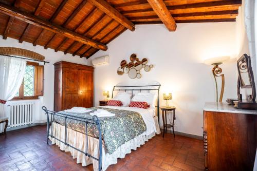 a bedroom with a bed and a wooden ceiling at Borgo la Pieve in Florence
