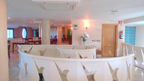 a white room with a table and chairs at Hotel Nueva Plaza in Maliaño