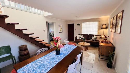 a living room with a dining table and a living room at Nogales House, by Pewma Apart Hotel in Chillán