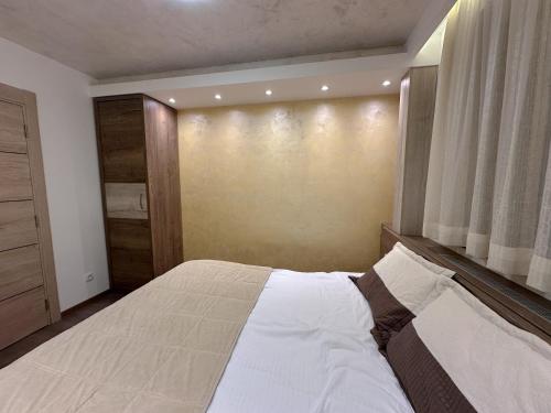 a bedroom with a bed and a large window at MB Apartmani Kopaonik in Kopaonik