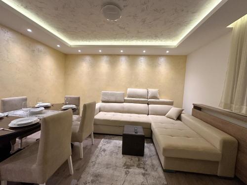 a living room with a couch and a table at MB Apartmani Kopaonik in Kopaonik