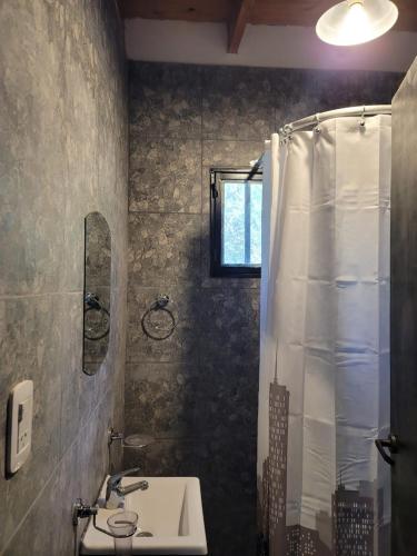a bathroom with a sink and a shower at Estudio Relax Las Sierras in El Volcán