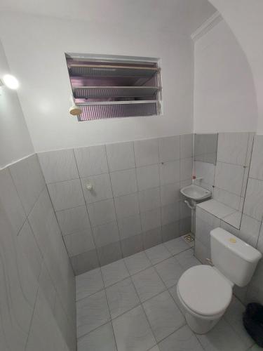 a bathroom with a toilet and a sink at Pousada Casa Sonhos in São Luís