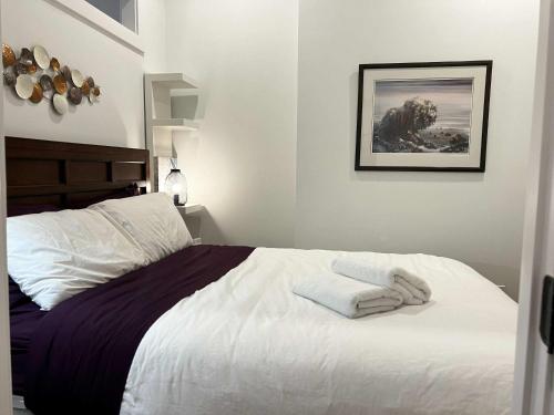 a bedroom with a bed with two towels on it at Urban Sophistication, Ocean View, Unit 513 in Halifax