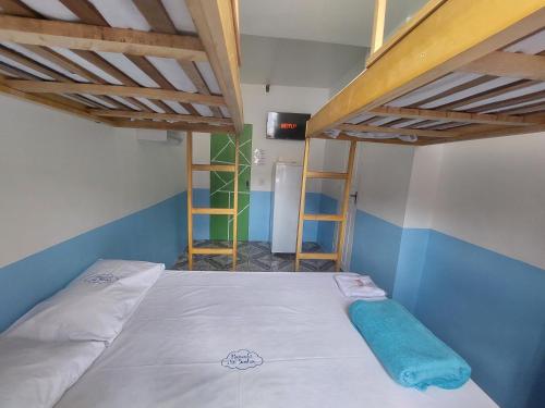 a bedroom with two bunk beds and a ladder at Pousada Casa Sonhos in São Luís