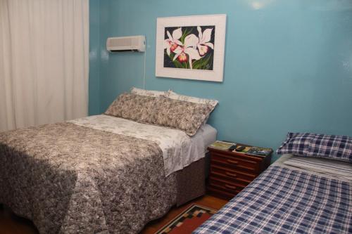 a small bedroom with two beds and a night stand at Pousada Charme da Serra in Bom Jardim da Serra