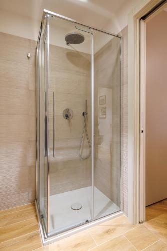 a shower with a glass door in a bathroom at Corte Trastevere Living in Rome