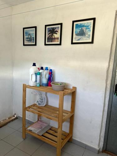 a shelf with bottles on it next to a wall at Edara Home - Vivienda completa in Gáldar