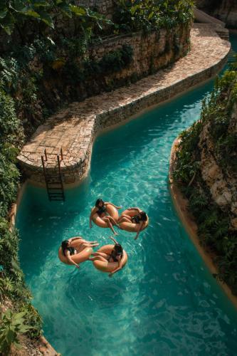 a group of people in a pool in the water at Hacienda Cenote San Ignacio in Chocholá
