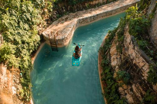 an aerial view of a boat in a body of water at Hacienda Cenote San Ignacio in Chocholá