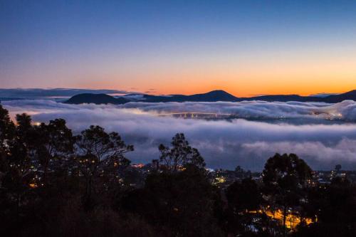 a view of a sea of clouds at sunset at Sandy Bay Townhouse in Sandy Bay