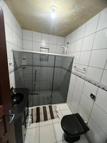 a bathroom with a shower and a toilet and a sink at Casa Diamantina in Ibicoara