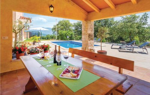 a table with wine glasses on it in a patio at Holiday Home Barisici V in Šumber
