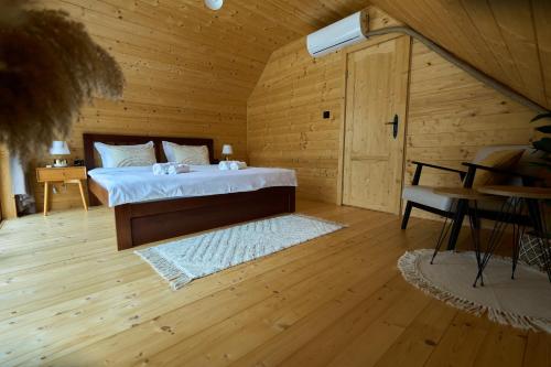 a bedroom with a bed in a wooden room at Pino House Zlatibor-Tornik in Ribnica