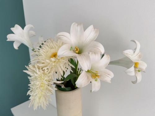 a white vase with white flowers in it at Stoneleigh Retreat 4BR Entire Home in Middlesbrough