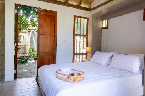 a bedroom with a bed with a basket on it at Tiny Village Cartagena Boutique Resort in Tierra Bomba