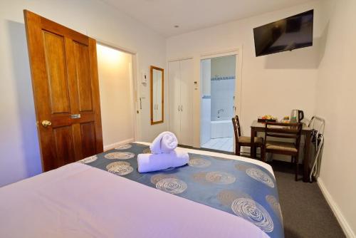 a bedroom with a bed with a stuffed animal on it at Tranquilles Bed & Breakfast in Port Sorell