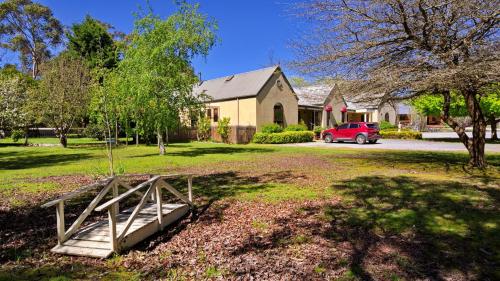 a house with a wooden bridge in front of a yard at Tranquilles Bed & Breakfast in Port Sorell