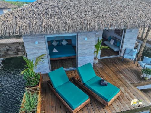 an overhead view of a deck with chairs and a thatch roof at CoralBay Bungalows Solarte in Solarte
