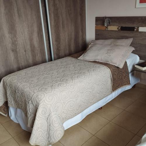 a small bed in a room with at By Muni Apartamentos Premium in Tanti