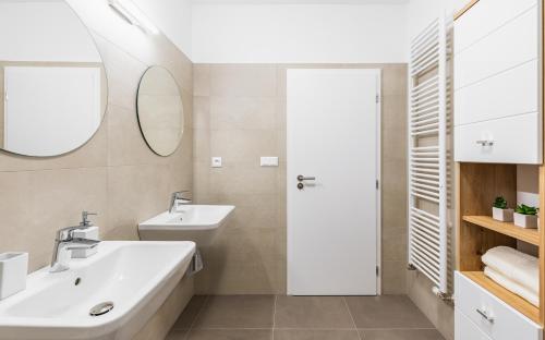 a bathroom with a sink and a mirror at BNB Urban Oasis Bajkalska in Bratislava