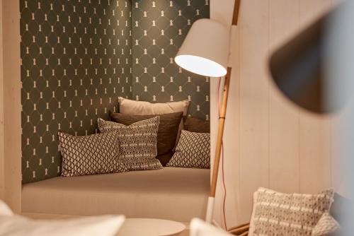 a room with a couch with pillows on it at Hotel Rössle in Au im Bregenzerwald