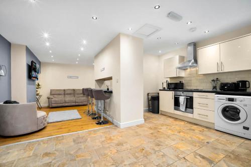 a kitchen and living room with a washer and dryer at Harborne House, Perfect for Contractors & Families, sleeps 8 in Birmingham